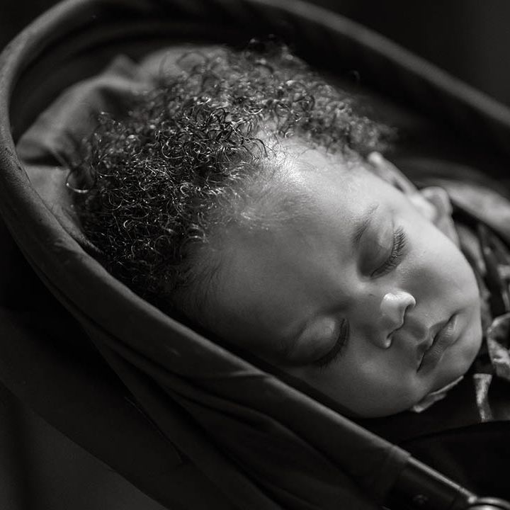 Black & white image of sleeping baby on wedding day