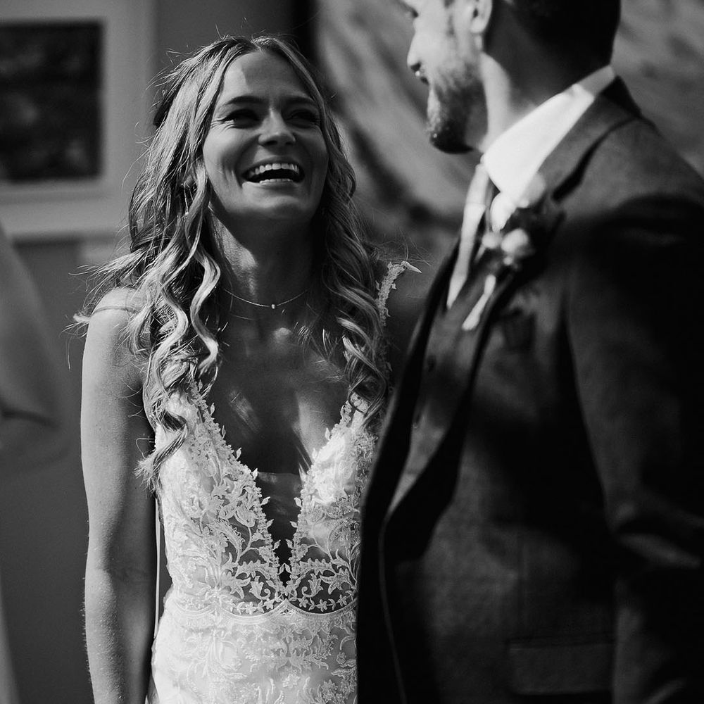 Bride and groom smile at each other on their wedding day 