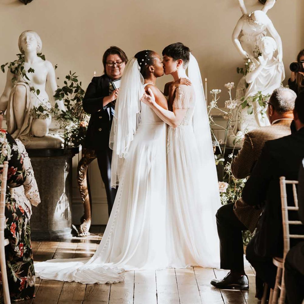 Lesbian wedding at Elmore Court with two brides in lace and tulle dresses 