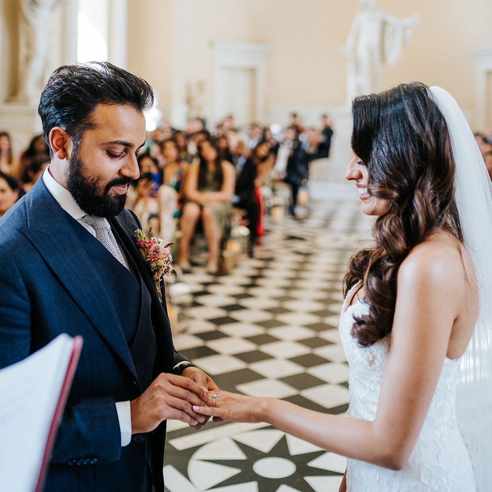 Bride & groom exchange rings during wedding ceremony at Syon Park