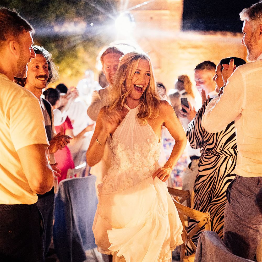 Bride and groom dance down the aisle between the banquet wedding tables 