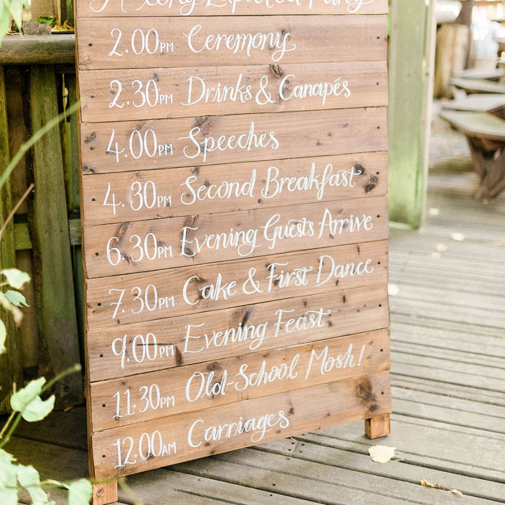 Wooden board wedding signage with white writing 