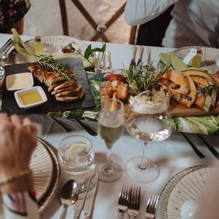 Charcuterie wedding food with cured meats, fresh fruit, bread, hummus and other dips 