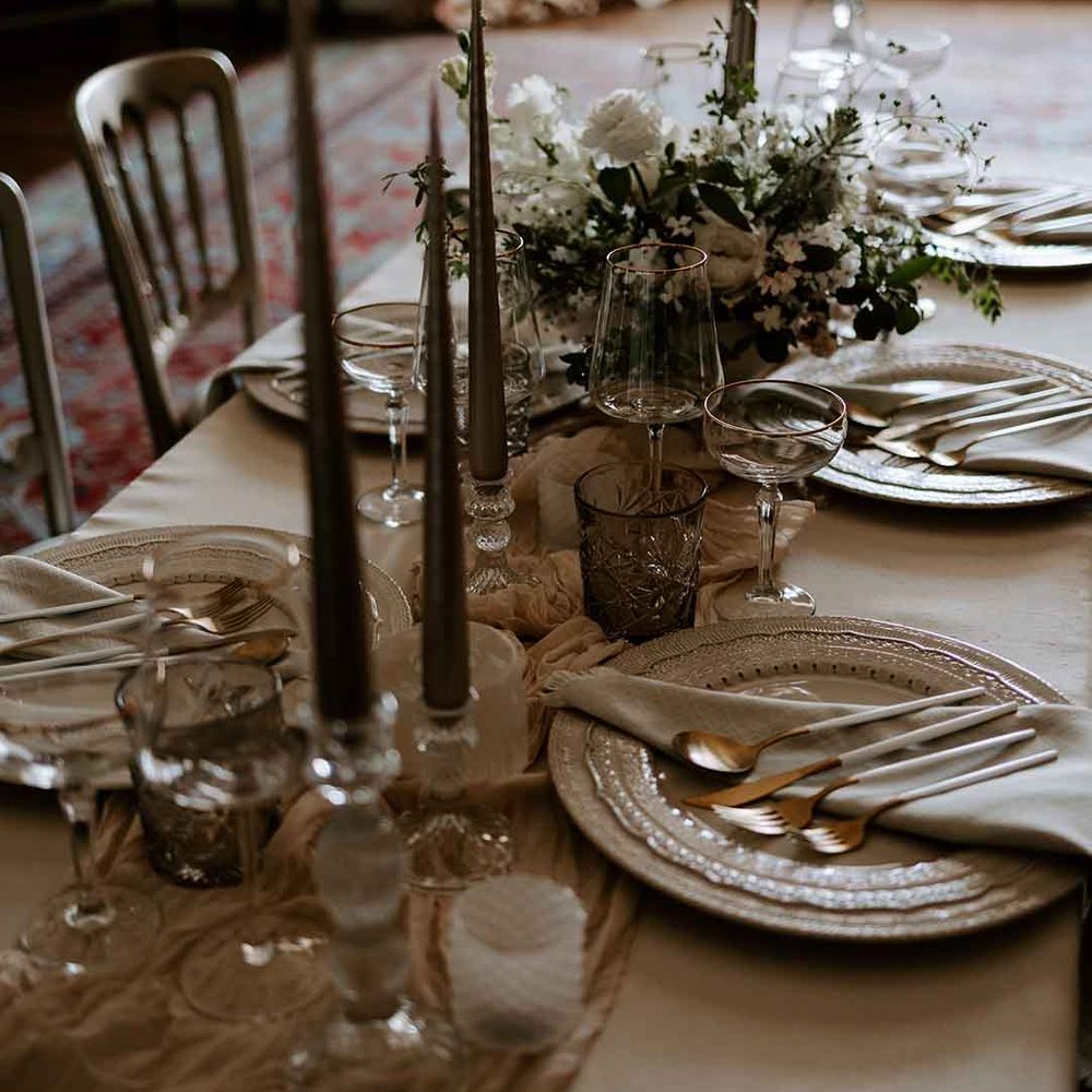 elegant wedding table decorations with taper candles and white centrepiece flowers 