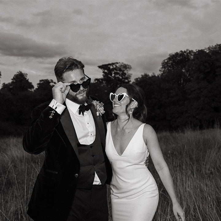 Bride and groom in stylish wedding sunglasses for couple photo 