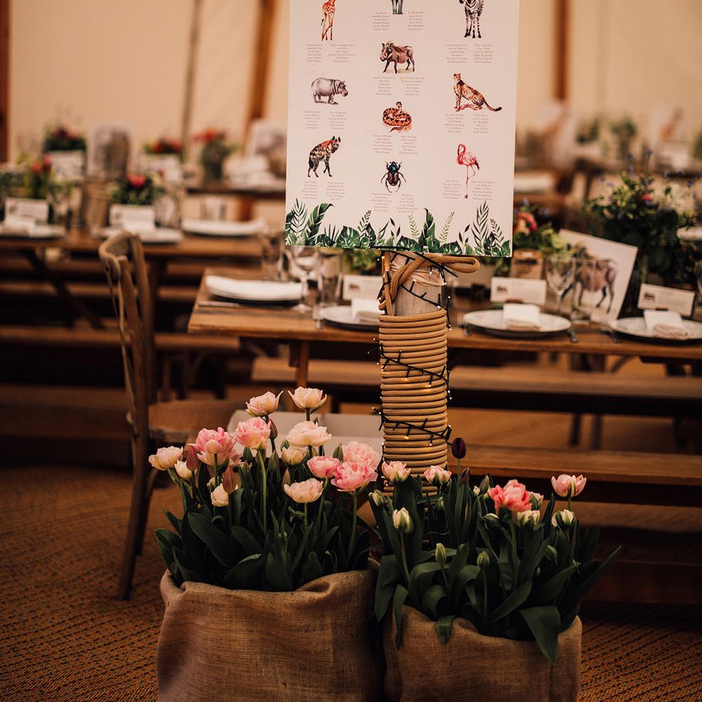Pretty pink tulip wedding flower arrangements with animal inspired wedding seating chart 