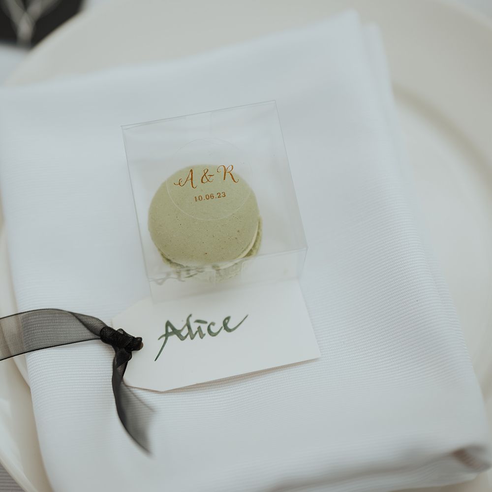 green macaroon wedding favour in a clear box 