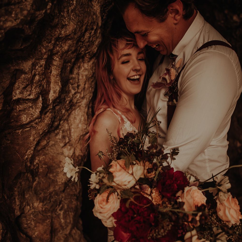 Bride and groom laughing at beach cove wedding photography