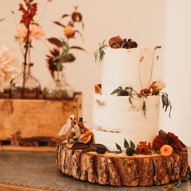 Rustic semi naked wedding cake on tree stump cake stand 