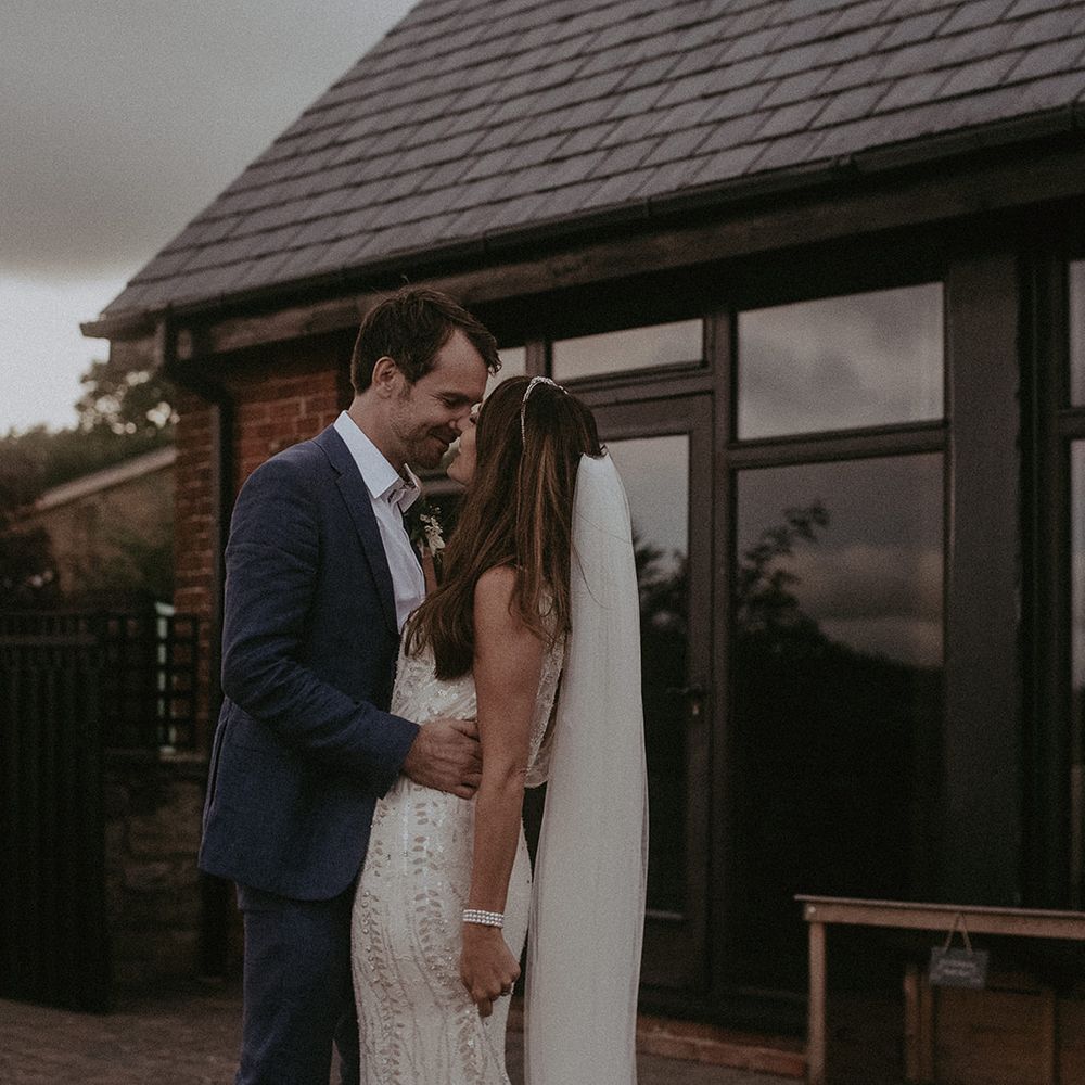 Bride & groom kiss outdoors on their wedding day