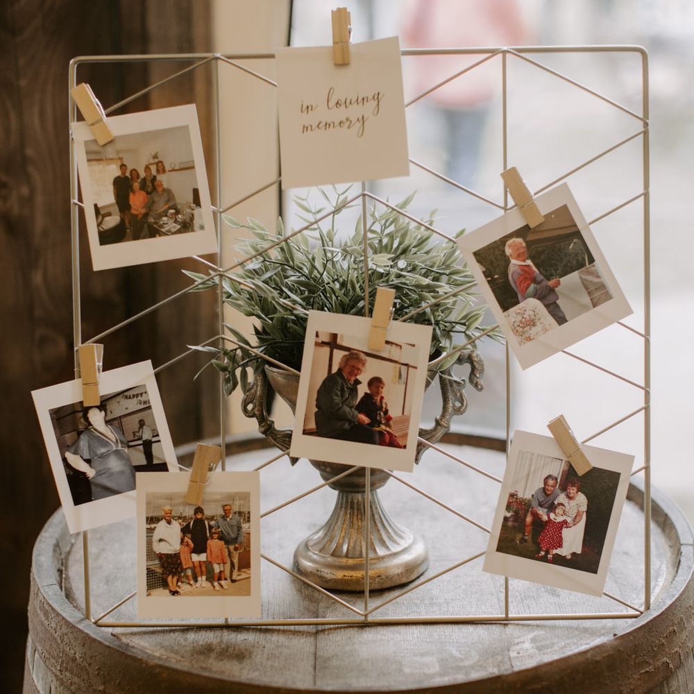 Polaroid pictures of old photos pegged to steel 
