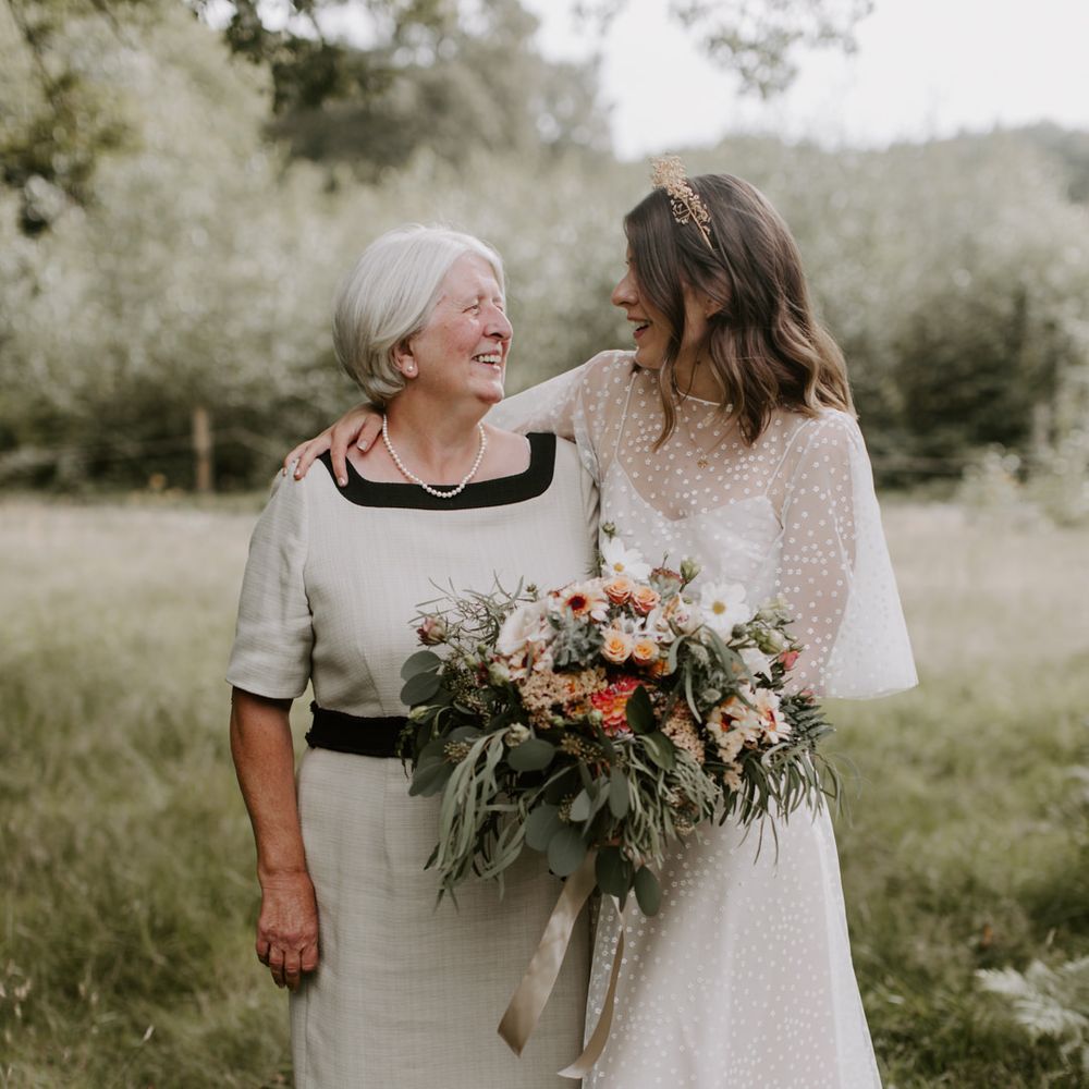 Bride stands with her mother on her wedding day