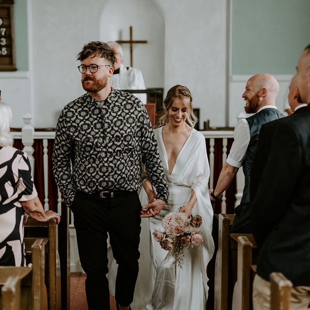 Bride & groom walk down the aisle after wedding ceremony