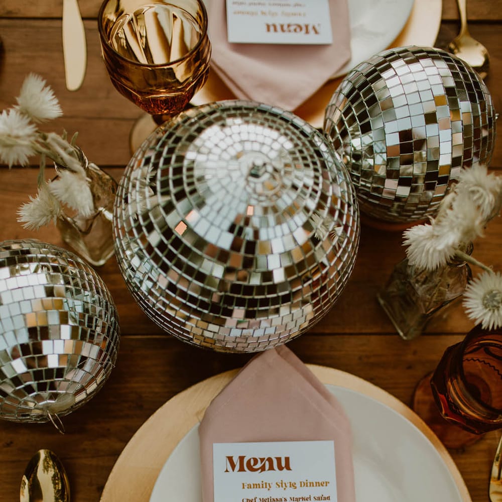 Retro boho tablescape complete with disco balls