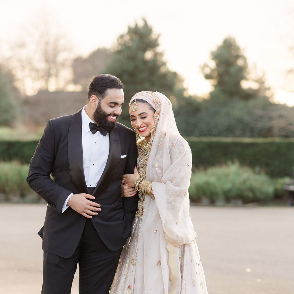 Bride & groom stand outdoors at the Isla Gladstone Conservatory