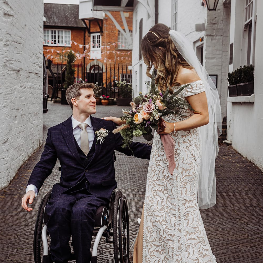 Bride and groom reach for each other ready for their hotel wedding 