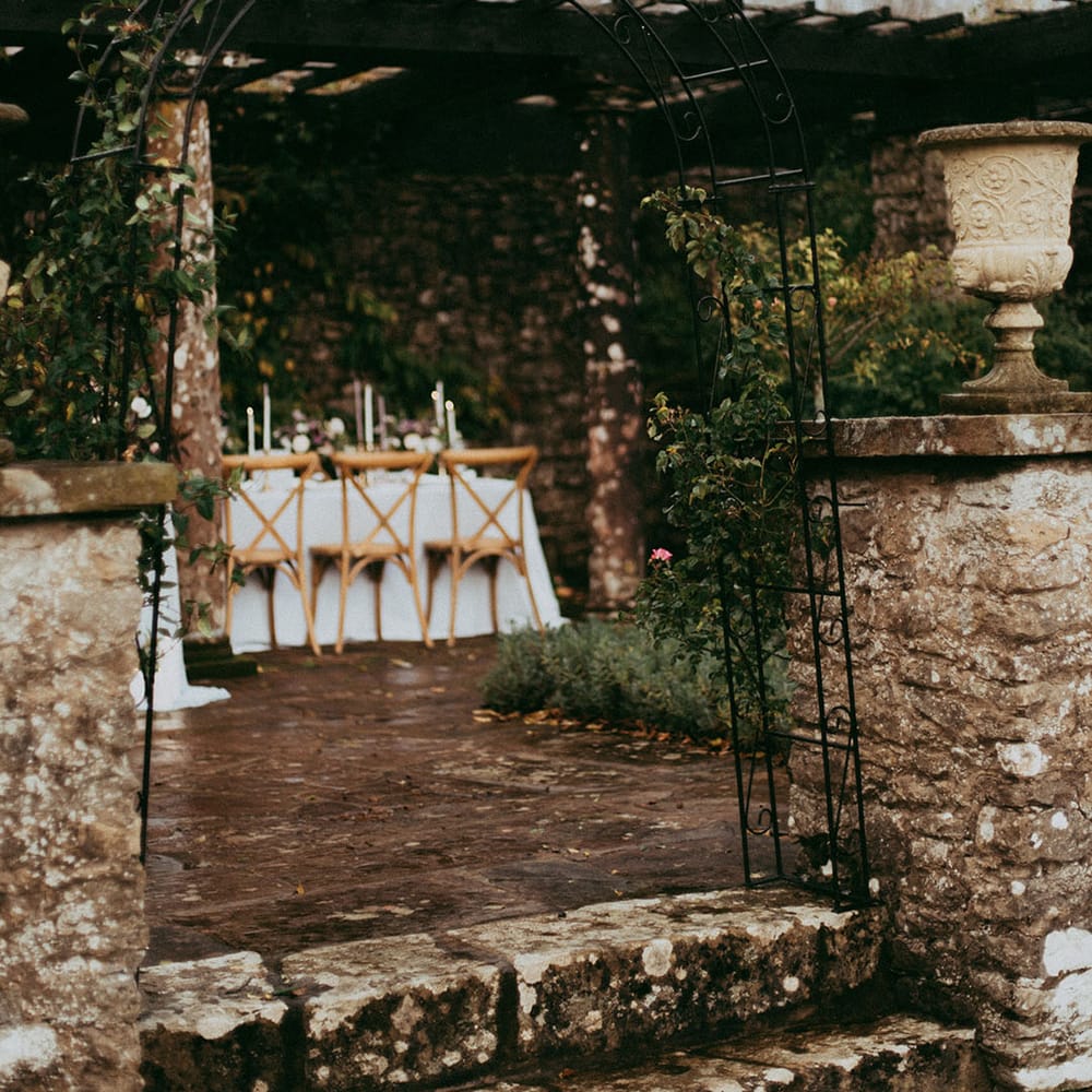 Black delicate arch at Holesfoot wedding going through to outdoor minimal wedding tablescape 