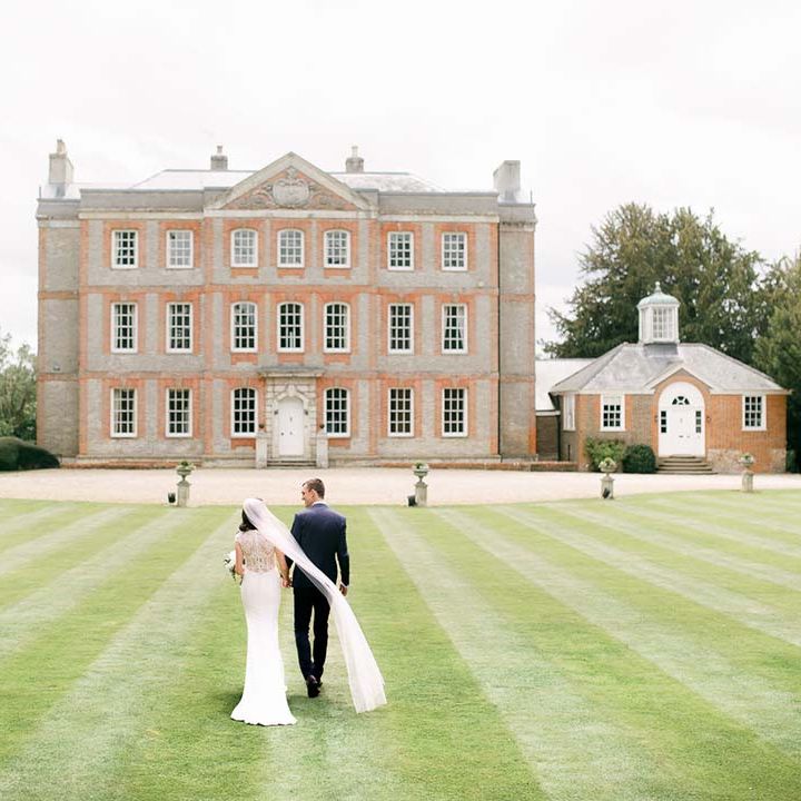 Bride and groom walking I the grounds of their Ardington House Oxfordshire wedding venue