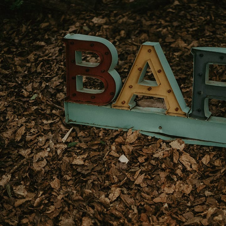 Colourful industrial style metal bar signage at outdoor wedding 