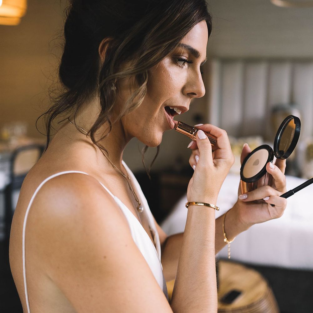 Bride puts on lipstick from Charlotte Tilbury 
