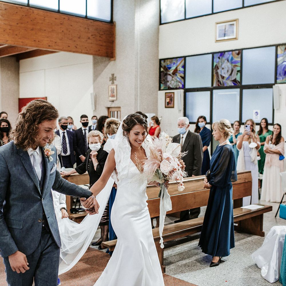 Bride and groom walking down the aisle together at their Italian destination wedding 