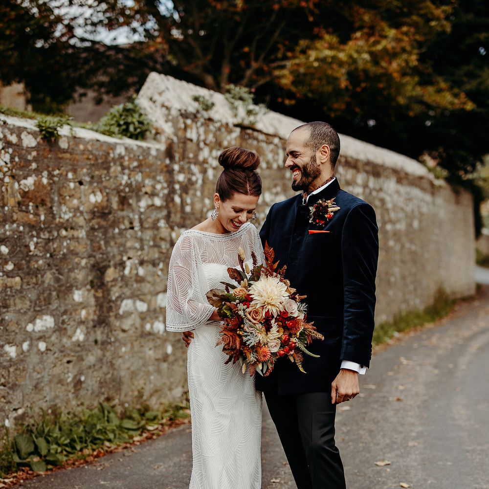 Bride & groom stand together outdoors after wedding ceremony