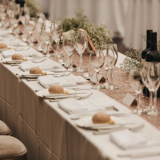 Top table with rose gold glitter table runner and gypsophila flowers 