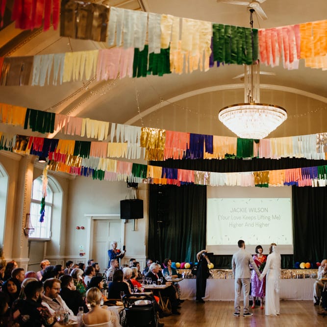 Celebrant led wedding ceremony with colourful streamer DIY decor and Motown Sing a long