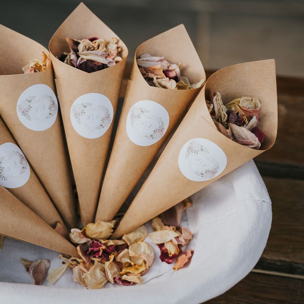 Brown paper cones with white stickers filled with confetti 