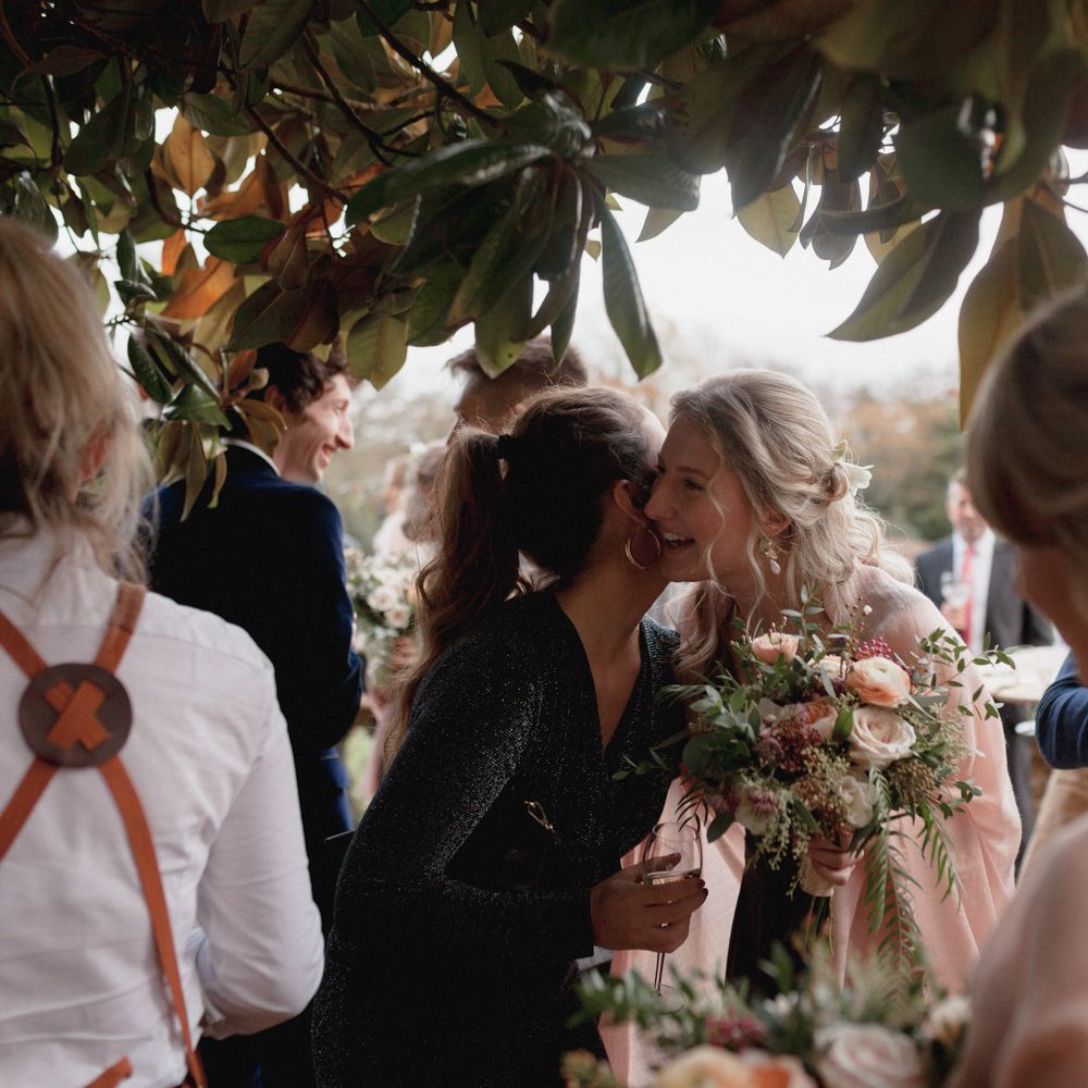 Wedding guests hugging at garden wedding