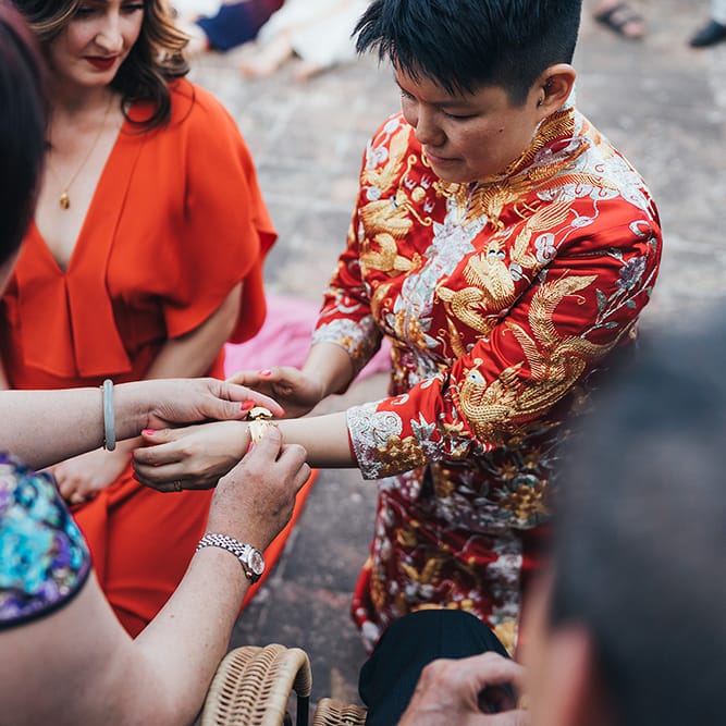 Bride has bracelet given to her by wedding guest