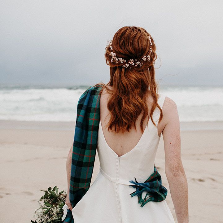 Bride with red hair with half up half down wavy wedding hairstyle 