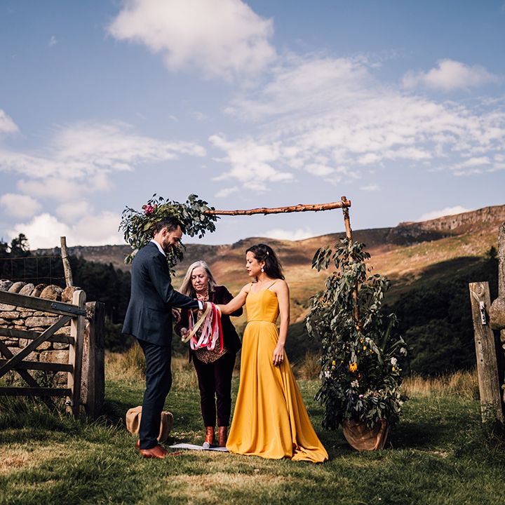 Bride & groom during handfasting ceremony outdoors
