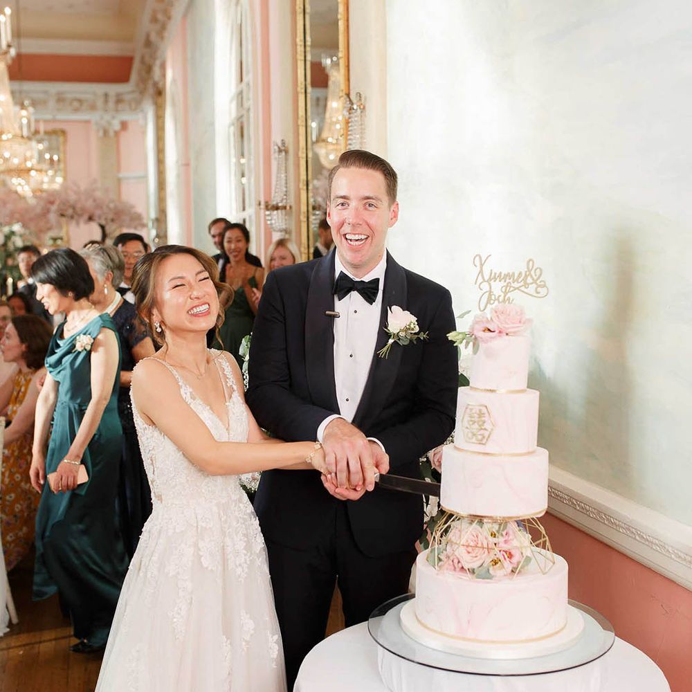 Bride & groom cut their wedding cake during reception