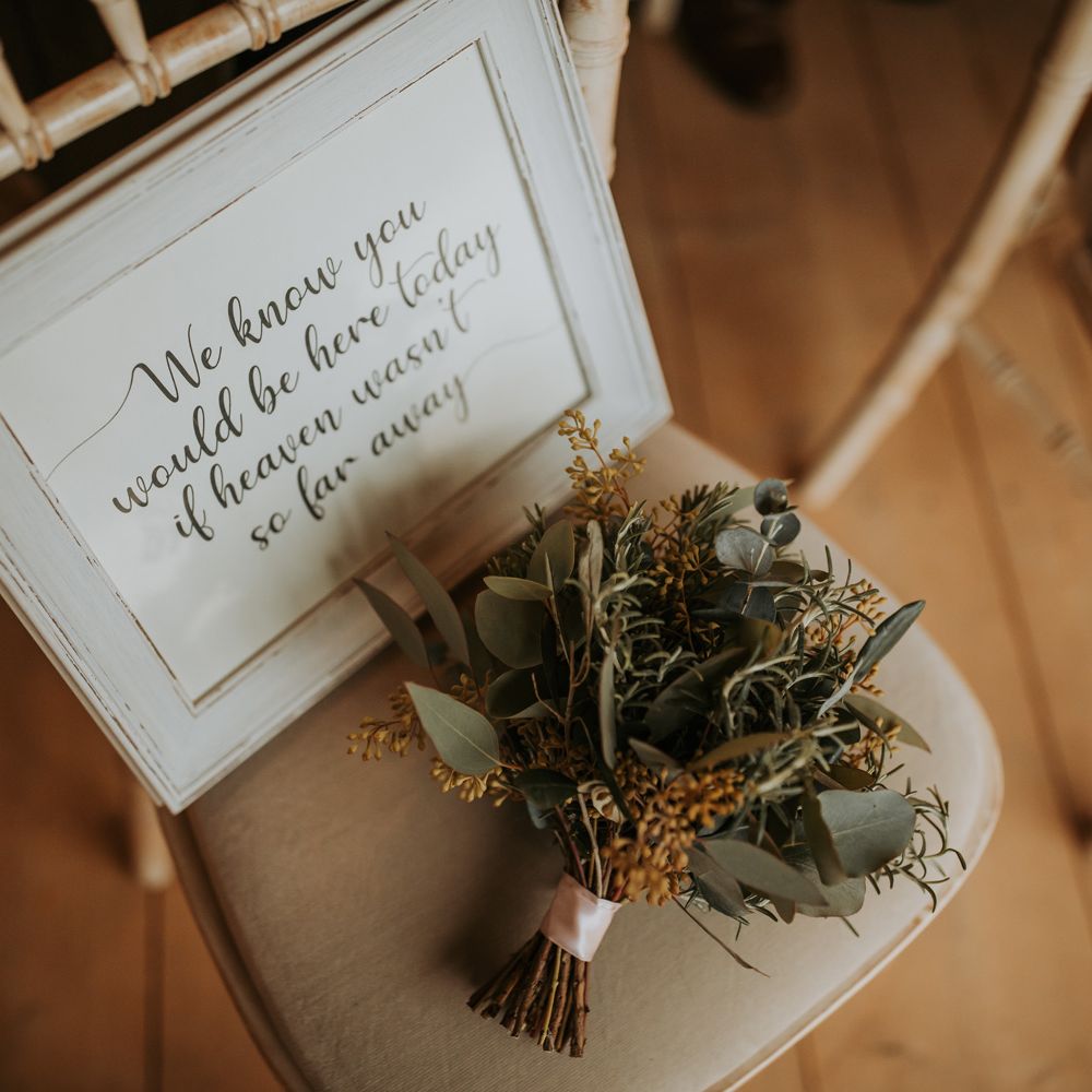 Dried floral and foliage bouquet with framed remembrance wedding sign for rustic barn wedding
