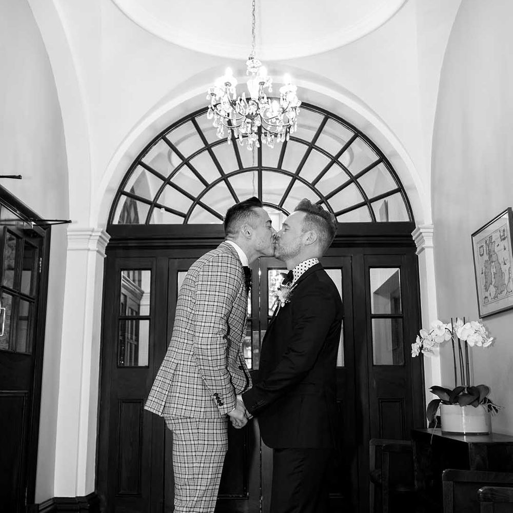 Grooms kiss at Chelsea Old Town Hall on their wedding day