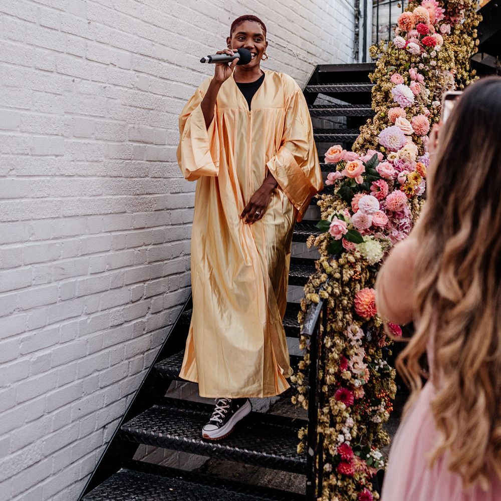 Flash mob choir at Loft Studio's London with pink wedding flowers decorating the staircase 