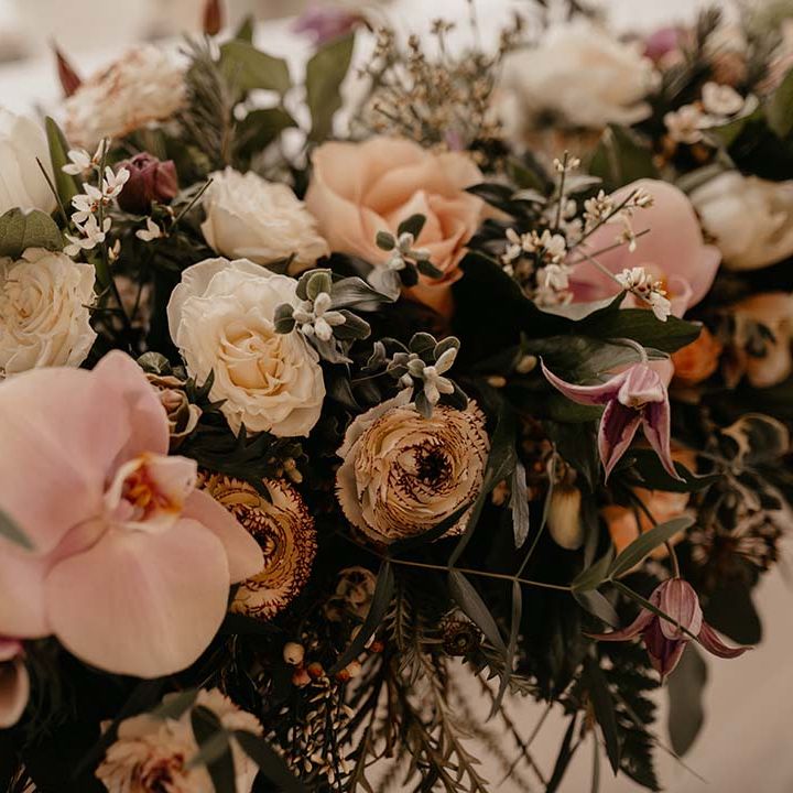 Mixed white, pink and yellow floral bouquet at multicultural wedding