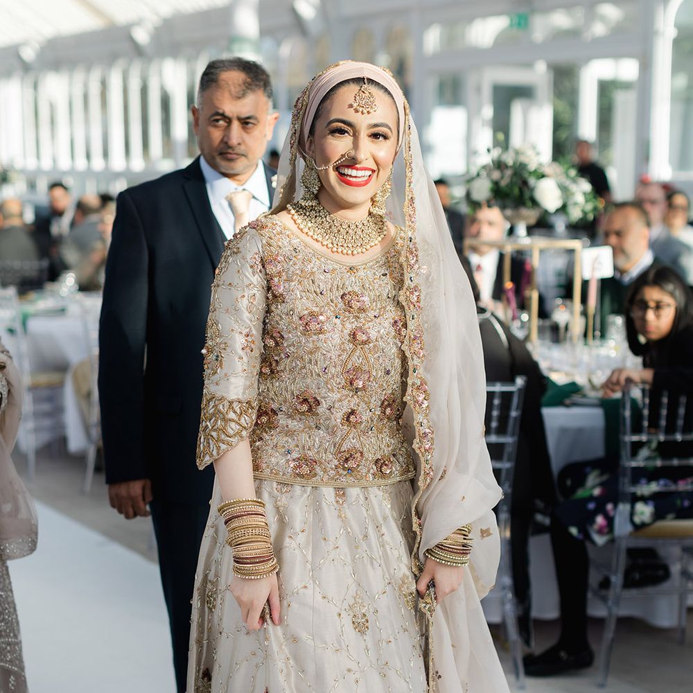 Bride smiles brightly on her wedding day wearing traditional saree and red lipstick 