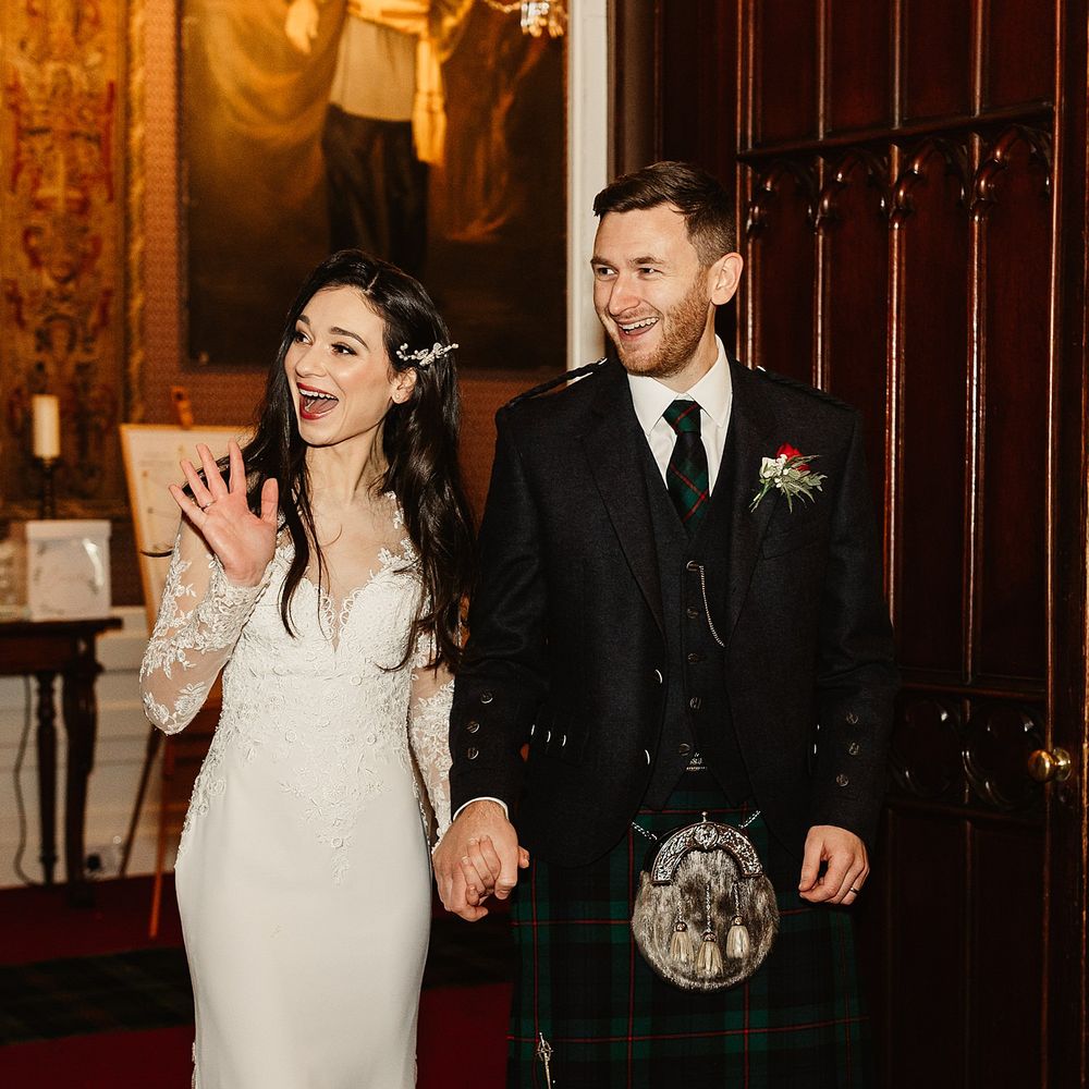 Bride & groom walk into wedding reception at Drumtochy Castle on their wedding day