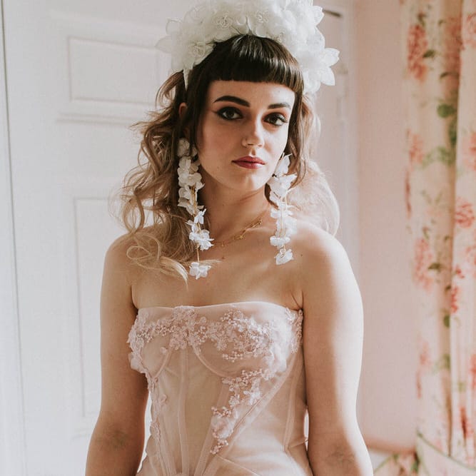 Bride in a pink strapless wedding dress by Felisiti Greis with tulle skirt, corset bodice and 3D flower detail