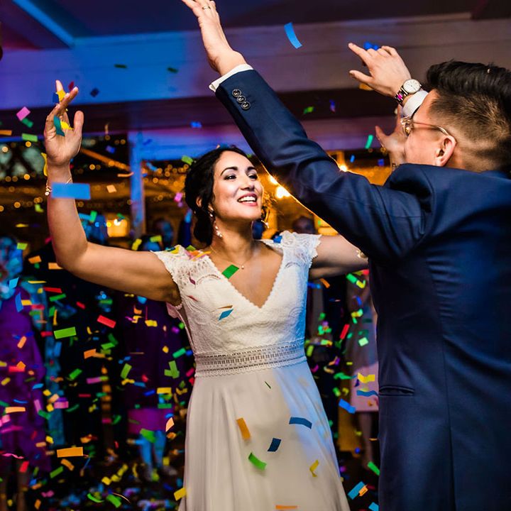 Bride dances with her groom during colourful confetti cannon 