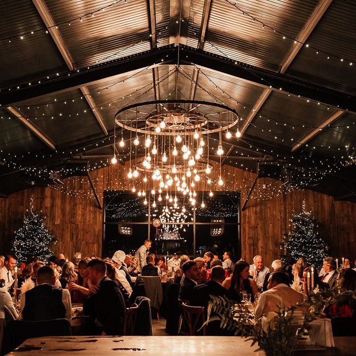 Silchester Farm wedding venue in Hampshire with big festoon lighting installation decorated for Christmas winter wedding