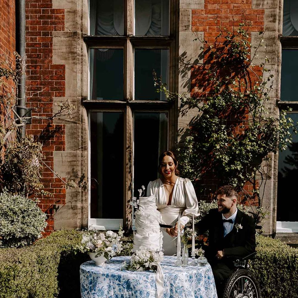 interabled couple cutting the wedding cake at Capesthorne Hall