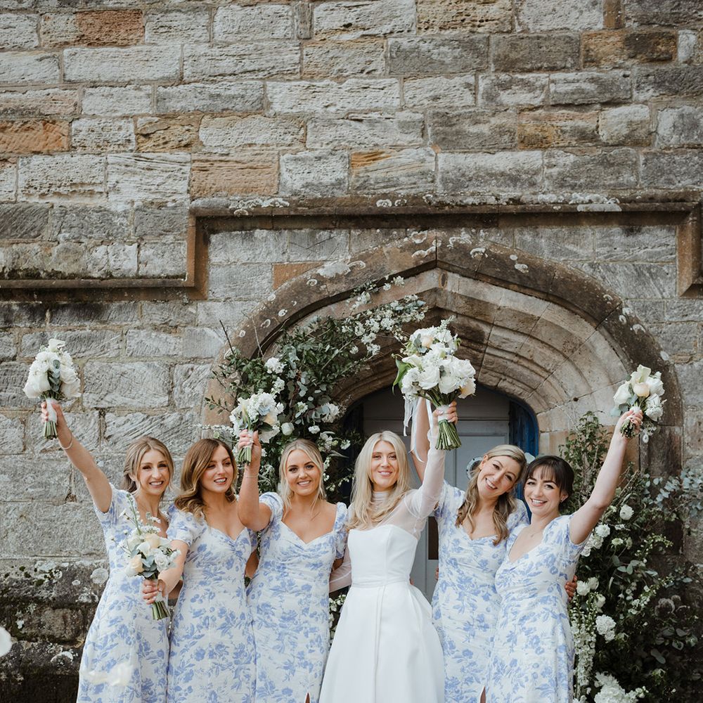 Bridesmaids in blue floral patterned bridesmaid dresses with bride in Jessica Bennett dress 