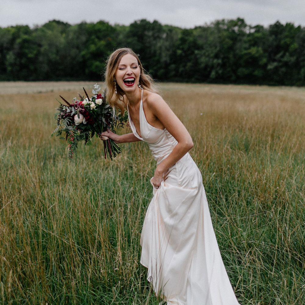 Beautiful bride in halterneck wedding dress and red lipstick