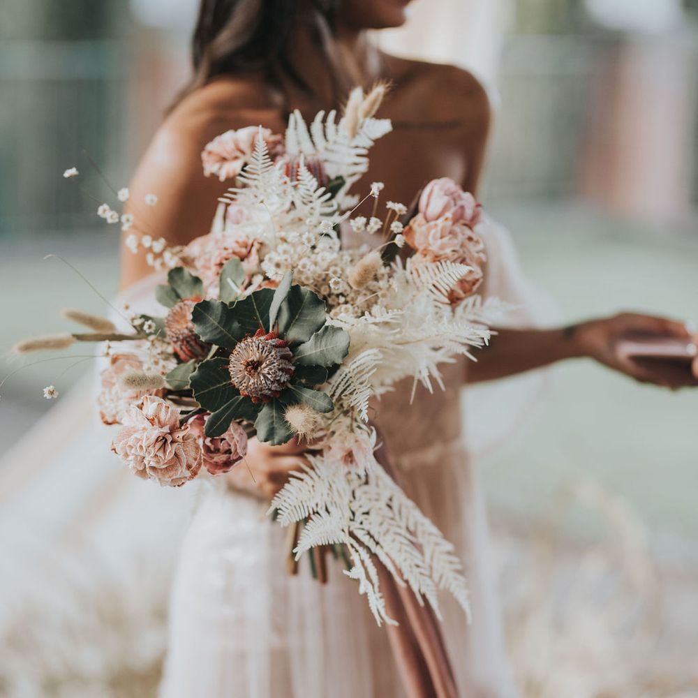 Pink wedding bouquet with natural grasses and foliage 