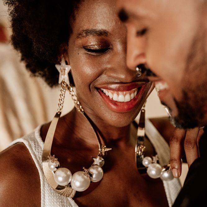 Bride & groom smiling together in black and white wedding decor 