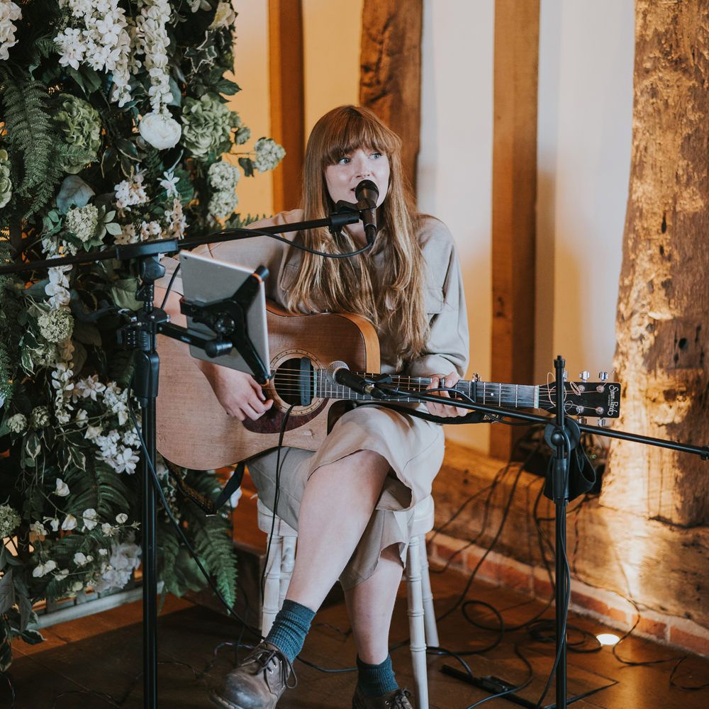 Acoustic guitarist plays and sings 