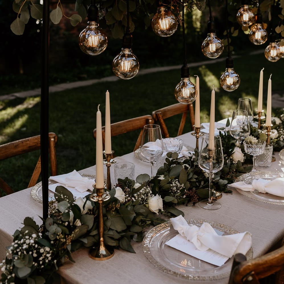 Foliage and white rose table runner and installation at intimate wedding reception table 